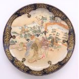 A Japanese Meiji period Satsuma plate with cobalt blue border and central panel of figures with