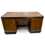 An Art Deco walnut veneered and ebonised twin pedestal desk, the front with single drawer flanked by