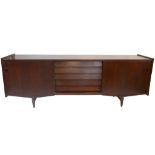 A large stained teak sideboard with twin sliding doors each enclosing a single shelf flanking five