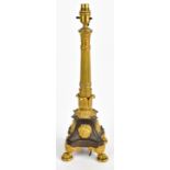 A mid-19th century French bronze and ormolu table lamp with foliate detailed fluted column on shaped