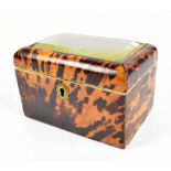 A 19th century tortoiseshell tea caddy of rectangular form with glazed top, the hinged cover