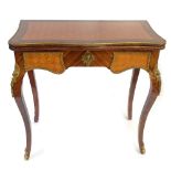 A reproduction French kingwood foldover card table with cast brass rim and applied panels, raised on