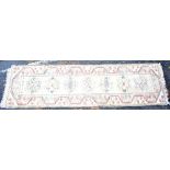 A Middle Eastern runner with floral detail on cream ground, 290 x 81cm.Additional InformationSome