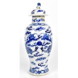 An early 20th century Chinese blue and white porcelain lidded jar, painted with four claw dragons,