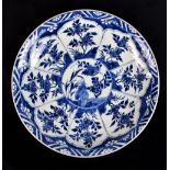 A Chinese Kangxi period porcelain charger painted in underglaze blue with floral decoration and with