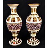 A pair of 19th century Bohemian glass vases with panelled and hobnail cut decoration with gilt