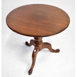 A 19th century mahogany circular topped table on turned and knopped column to three outswept