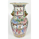 A 19th century Chinese Canton twin handled vase painted with stylised figures in panels inset within