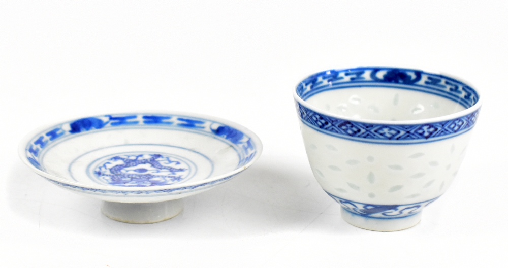 A Chinese 'rice inset' tea bowl painted with a floral spray to the centre and a shallow dish