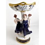 ROYAL DUX; a large figural centre piece modelled as three maidens supporting circular bowl decorated