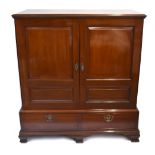 A late George III red walnut press cupboard, the moulded rectangular top above two double panelled