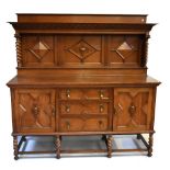 A good early 20th century carved oak sideboard with panelled back above three central drawers