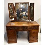 A 1930s oak dressing table with triple mirror above two carved drawers and four further drawers,