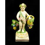 An early 19th century pearlware cherub figure representing Summer holding a basket of flowers