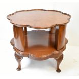 A reproduction burr walnut quarter veneered rotating bookcase/occasional table, the shaped top above