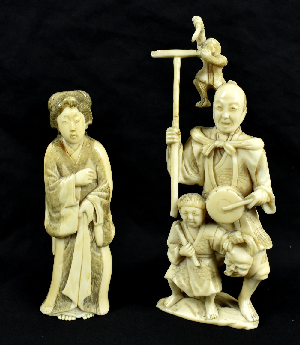 Two Japanese Meiji period carved ivory okimonos, the larger a group featuring man, child and monkey,