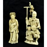 Two Japanese Meiji period carved ivory okimonos, the larger a group featuring man, child and monkey,