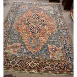 A large Middle Eastern rug with stylised detail on blue and salmon grounds, approx 315 x 230cm.