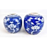 Two similar early 20th century Chinese blue and white prunus decorated jars, height 14cm and 13cm,