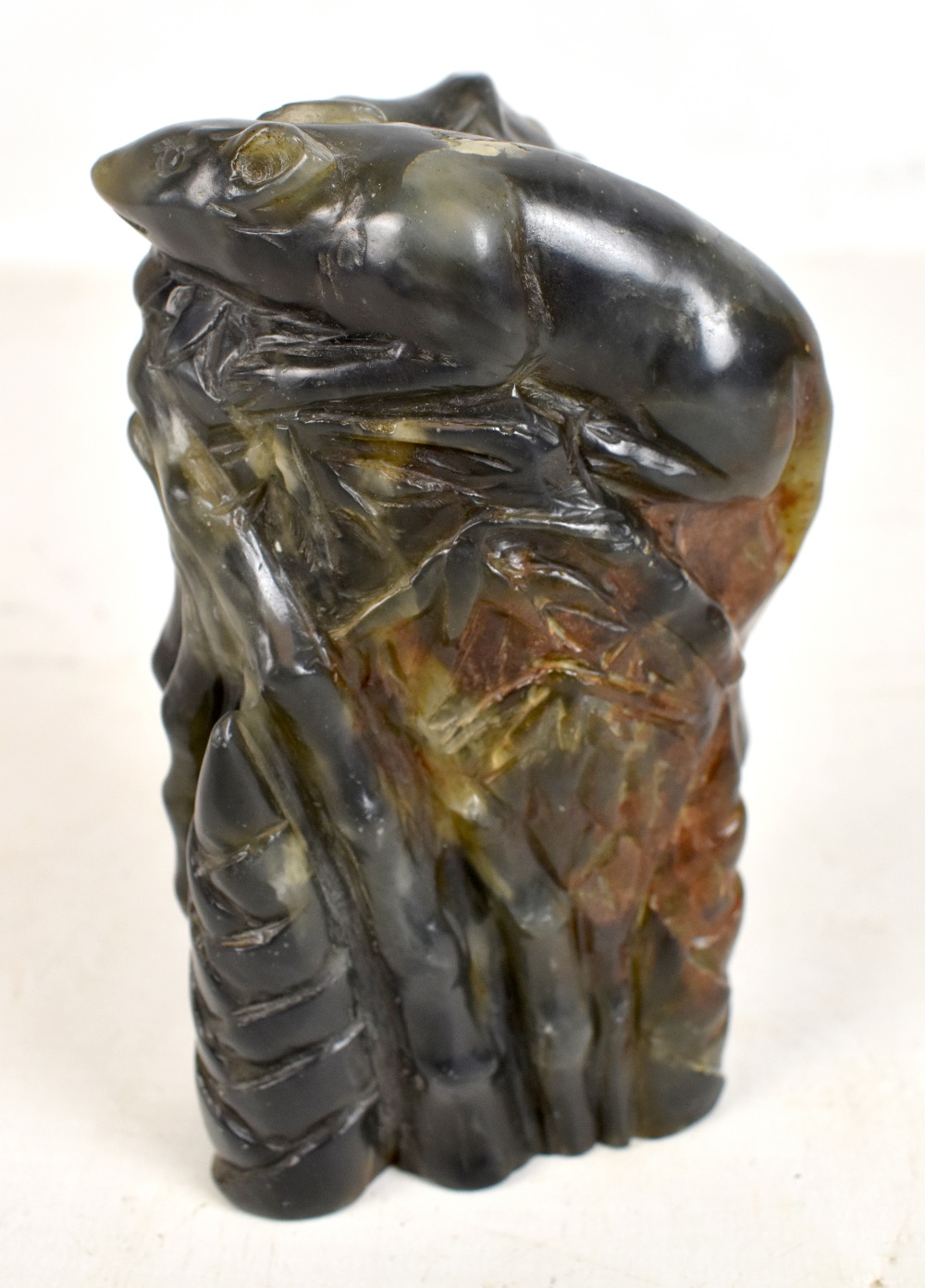 A Chinese soapstone carving of a rat upon bamboo shoots, height 13.8cm.Additional InformationSome