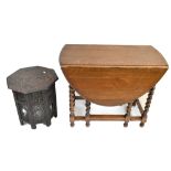 An oak oval drop leaf gateleg table on barley twist supports and an Eastern carved octagonal