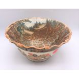 A large Japanese Meiji period Satsuma bowl with crimped rim and internal decoration of a palace with