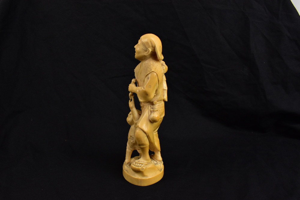 TOKYO SCHOOL; a good Japanese Meiji period carved ivory okimono modelled as a man holding a crab - Image 2 of 5