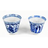 A near pair of Chinese blue and white tapering cups decorated with alternating panels of figures and