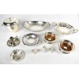 A small group of silver plated items including a pair of bottle coasters, chamberstick, model cat