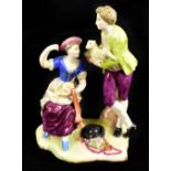 An 18th century French faience figure group of gentleman holding lamb and lady on shaped base,