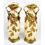 ROYAL DUX; a pair of large twin handled vases decorated in relief with fruit, with further floral