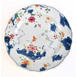 An 18th century Chinese porcelain unfinished Tobacco Leaf pattern plate with enamelled detail and