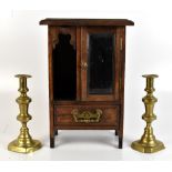 A small early 20th century stained pine cabinet with mirrored door above single base drawer,