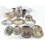 A group of silver plated items to include a pair of sauce boats and trays with cast floral