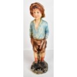 A mid-20th century plaster figure of a boy smoking a cigarette, impressed No. 740 to base reverse,