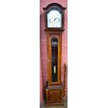 A 1920s/30s mahogany grandmother clock with bevelled glazed door beneath silvered dial set with