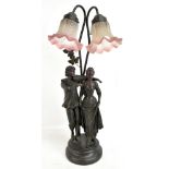 A modern decorative table lamp featuring a couple singing and playing the violin beneath two pink