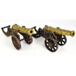 A pair of cast iron and brass table cannons, overall length 45cm, barrel length approx 28.5cm.