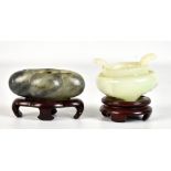 A Chinese polished hardstone quatrilobed brush washer, raised on shaped wooden stand, length 8cm,