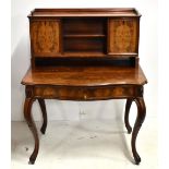 A mid-19th century French mahogany bonheur du jour, the upper section with twin cupboard doors
