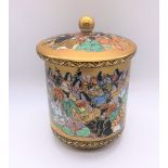 An unusual Japanese Meiji period Satsuma porcelain pot and cover painted with a band of figures,