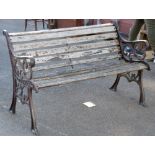 A garden bench with painted foliate motif cast iron supports and wooden slats, height 78.5cm,