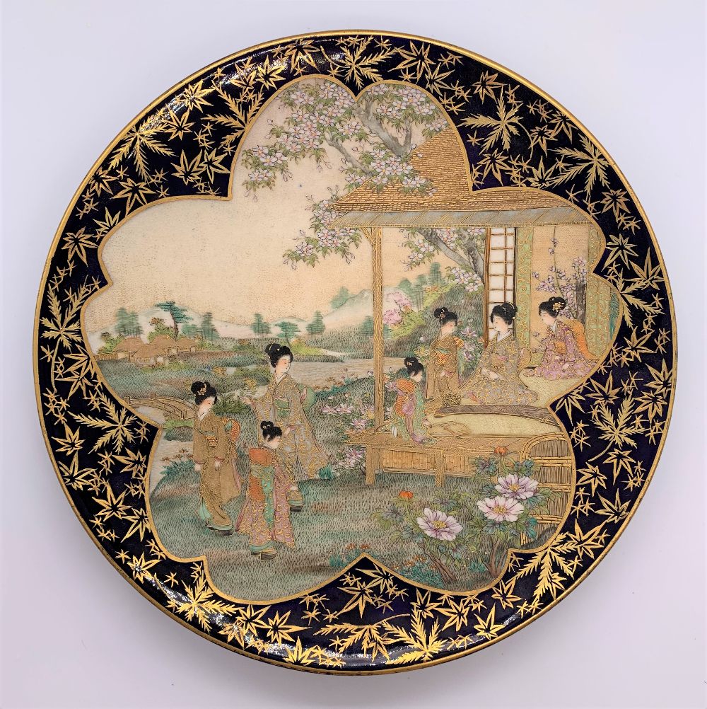 A Japanese Meiji period Satsuma plate with cobalt blue border and central panel of figures with