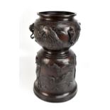 A good and large Japanese Meiji period bronze jardinière and stand cast in one, profusely