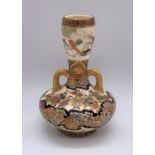 A Japanese Meiji period Satsuma twin handled vase of small proportions decorated with figures and