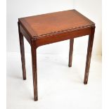 A small mahogany foldover card table.