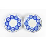 A pair of Chinese blue and white shallow circular dishes each decorated with roundels, set with