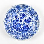 An 18th century Chinese blue and white floral decorated lobbed circular shallow bowl with painted