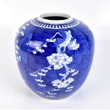 An early 20th century Chinese blue and white porcelain vase of bulbous form painted with prunus