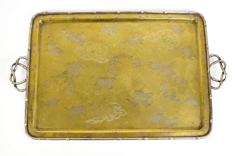 A Japanese Meiji period mixed metal tray with inlaid and engraved decoration of stylised phoenix and